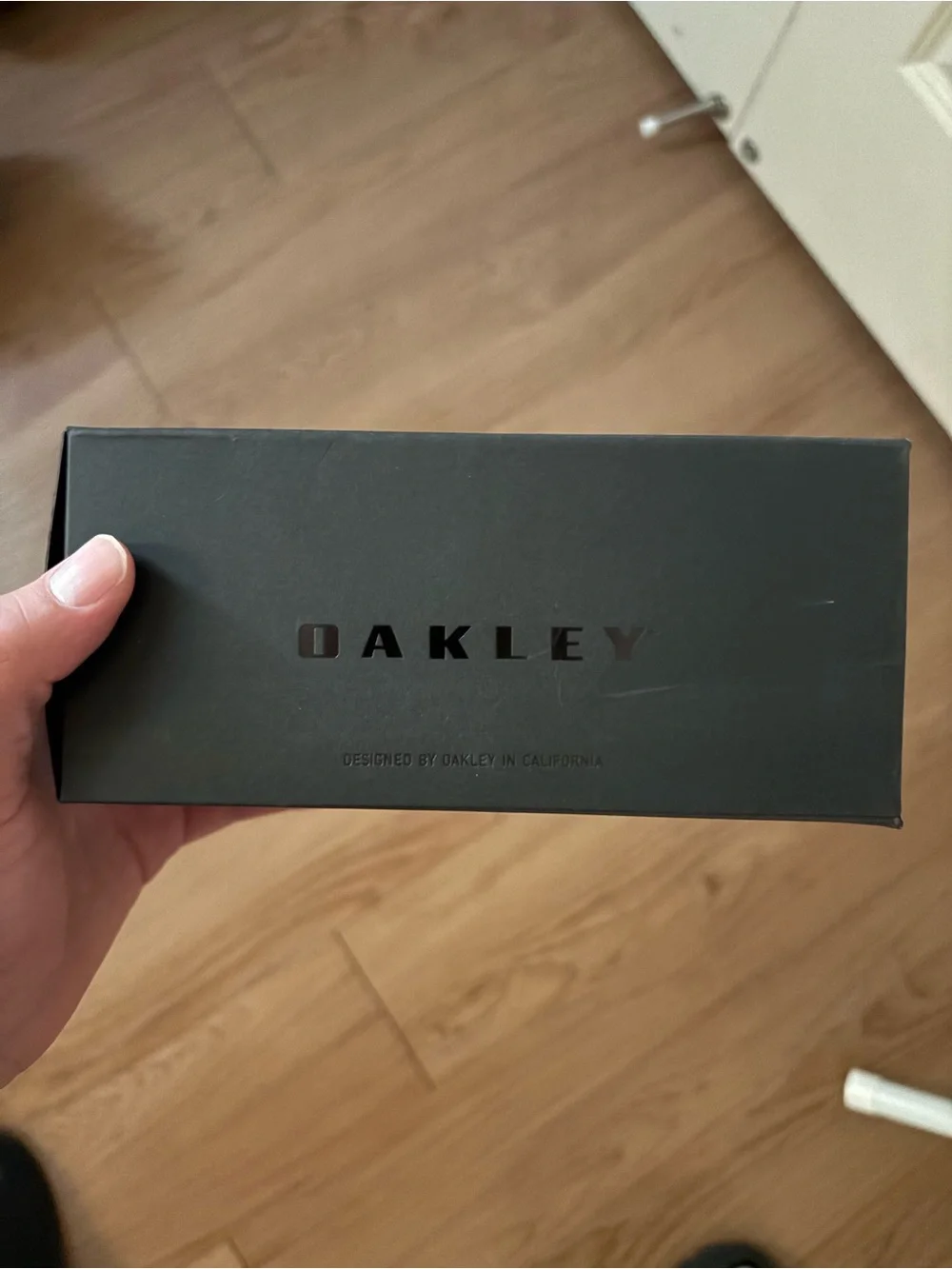 Oakley Black Frame Sunglasses with Red-Orange Mirror Lens